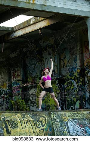 Caucasian woman stretching in abandoned loading dock View Large Photo Image Stock Image - Caucasian woman stretching in abandoned loading dock. Fotosearch