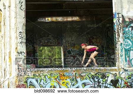 Caucasian woman stretching in abandoned loading dock View Large Photo Image Stock Image - Caucasian woman stretching in abandoned loading dock. Fotosearch