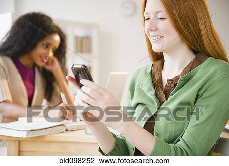 Caucasian woman text messaging on cell phone View Large Photo Image Stock Image - Caucasian woman text messaging on cell phone. Fotosearch