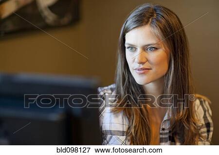 Stock Photo - Caucasian woman using computer. Fotosearch