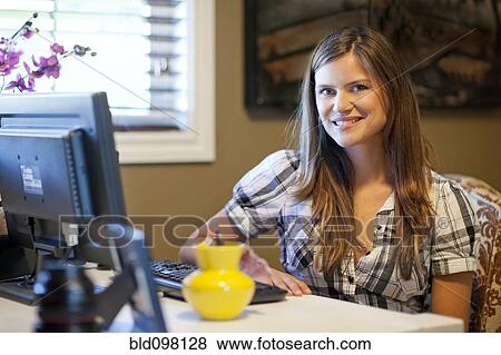 Stock Photo - Caucasian woman using computer. Fotosearch