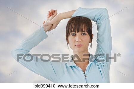 Stock Image - Caucasian woman with arms raised. Fotosearch