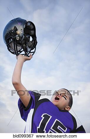 Stock Photo - Cheering mixed race football player. Fotosearch
