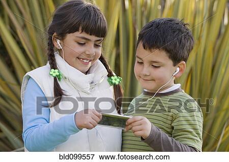 Chilean brother and sister sharing mp3 player View Large Photo Image Stock Photo - Chilean brother and sister sharing mp3 player. Fotosearch