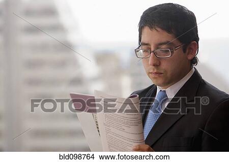 Picture - Chilean businessman reading report. Fotosearch