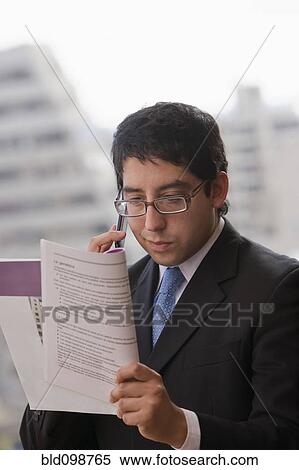 Chilean businessman reading report View Large Photo Image Stock Photography - Chilean businessman reading report. Fotosearch