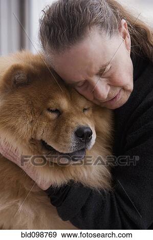 Stock Photo - Chilean woman hugging dog. Fotosearch