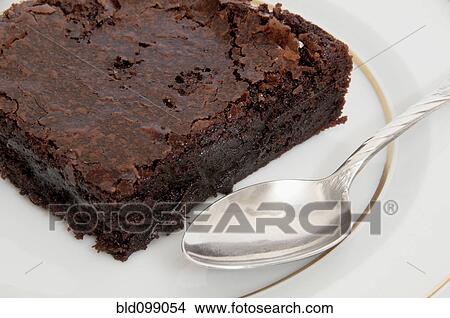 Picture - Close up of chocolate brownie and spoon. Fotosearch