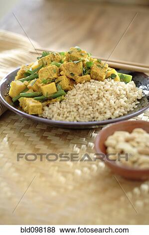 Stock Photo - Curry soy tempeh and rice in bowl. Fotosearch