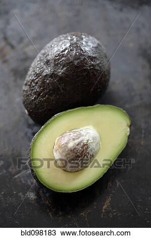 Stock Image - Cut open avocado. Fotosearch
