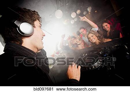 DJ playing music for crowd in nightclub View Large Photo Image Stock Image - DJ playing music for crowd in nightclub. Fotosearch