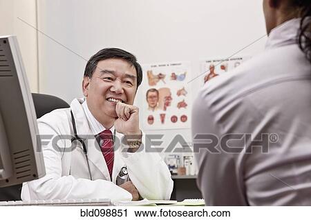 Doctor talking to patient in office View Large Photo Image Stock Image - Doctor talking to patient in office. Fotosearch
