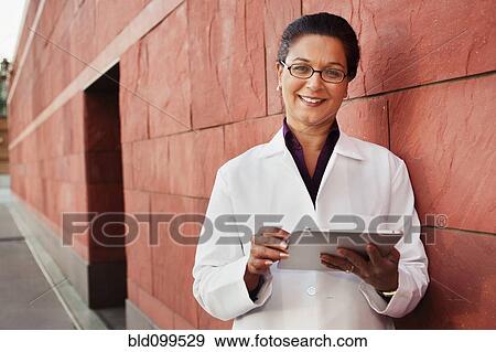 Doctor using digital tablet outdoors View Large Photo Image Stock Photo - Doctor using digital tablet outdoors. Fotosearch