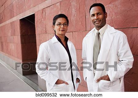 Stock Image - Doctors standing outdoors. Fotosearch