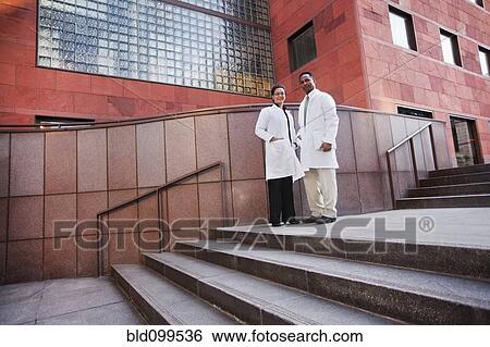 Doctors standing outdoors View Large Photo Image Stock Photograph - Doctors standing outdoors. Fotosearch