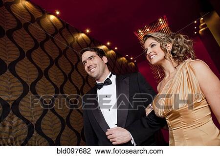 Stock Image - Elegant Hispanic couple walking together. Fotosearch