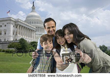 Stock Photo - Family taking self-portrait on vacation. Fotosearch