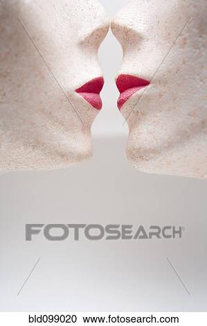 Stock Image - Female mannequin heads kissing. Fotosearch