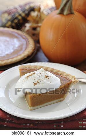 Stock Image - Fresh, homemade pumpkin pie with whipped cream. Fotosearch