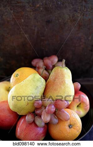 Stock Image - Fresh pears, oranges, apples and grapes. Fotosearch