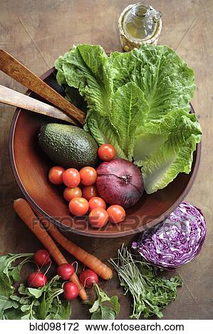 Stock Image - Fresh vegetables in wooden bowl. Fotosearch