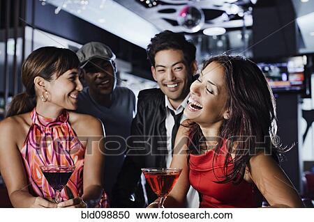 Friends drinking in nightclub View Large Photo Image Stock Image - Friends drinking in nightclub. Fotosearch