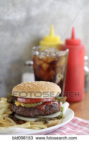 Stock Image - Hamburger and french fries in diner. Fotosearch