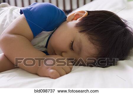 Stock Photo - Hispanic baby boy napping. Fotosearch