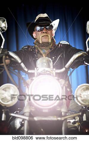 Hispanic biker sitting on motorcycle View Large Photo Image Stock Photograph - Hispanic biker sitting on motorcycle. Fotosearch