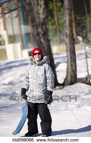Stock Photograph - Hispanic boy playing in the snow. Fotosearch