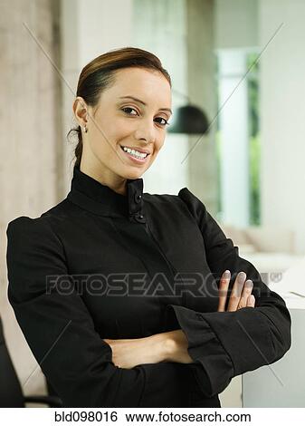 Stock Photograph - Hispanic businesswoman with arms crossed. Fotosearch
