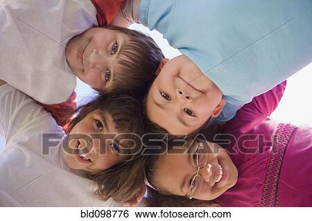 Hispanic children bending and looking down View Large Photo Image Stock Photograph - Hispanic children bending and looking down. Fotosearch