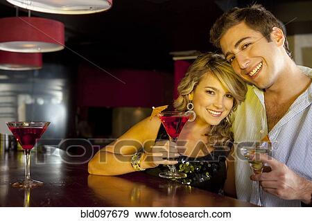 Stock Photo - Hispanic couple drinking martinis. Fotosearch