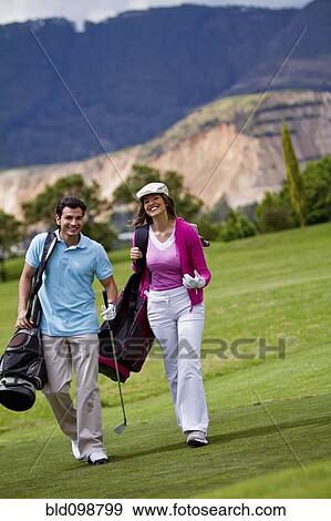 Stock Photo - Hispanic couple playing golf together. Fotosearch
