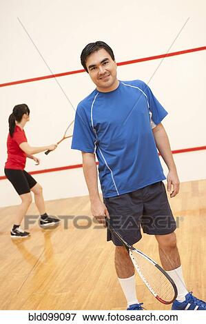 Hispanic couple playing racquetball View Large Photo Image Stock Photo - Hispanic couple playing racquetball. Fotosearch