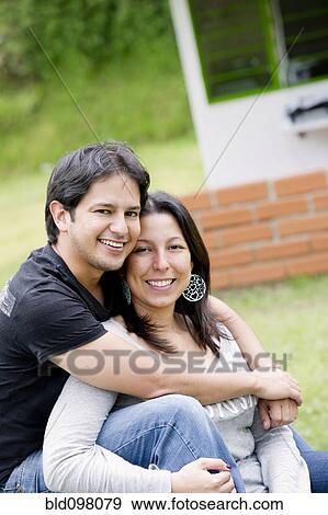 Stock Photo - Hispanic couple sitting together. Fotosearch