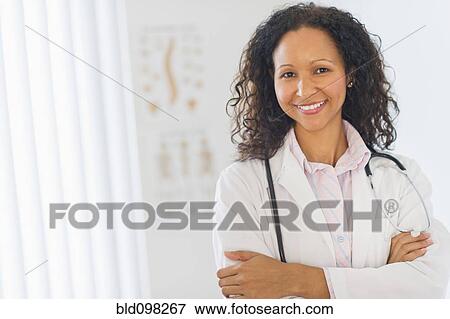 Stock Photo - Hispanic doctor standing in hospital. Fotosearch