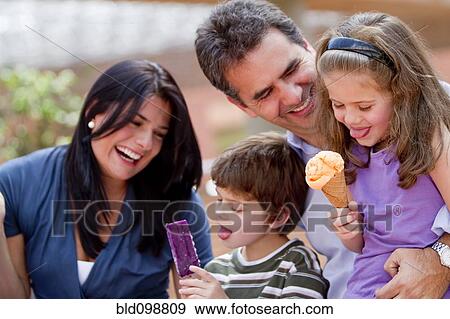 Hispanic family enjoying ice cream together View Large Photo Image Stock Photo - Hispanic family enjoying ice cream together. Fotosearch