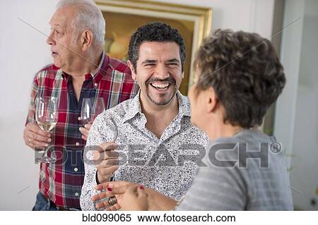 Stock Photography - Hispanic family enjoying party. Fotosearch