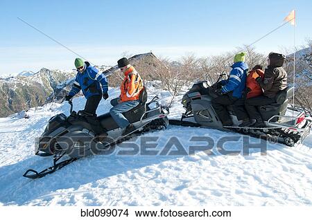 Hispanic family riding on snowmobiles through snow View Large Photo Image Picture - Hispanic family riding on snowmobiles through snow. Fotosearch