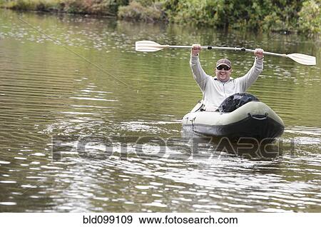 Hispanic man in kayak on river View Large Photo Image Stock Photo - Hispanic man in kayak on river. Fotosearch