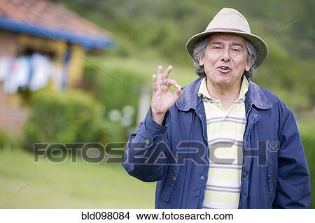 Picture - Hispanic man making okay gesture. Fotosearch