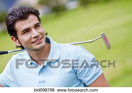 Stock Photo - Hispanic man playing golf. Fotosearch