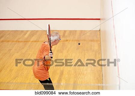 Picture - Hispanic man playing racquetball. Fotosearch