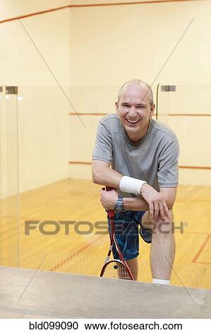Hispanic man relaxing after racquetball View Large Photo Image Stock Image - Hispanic man relaxing after racquetball. Fotosearch