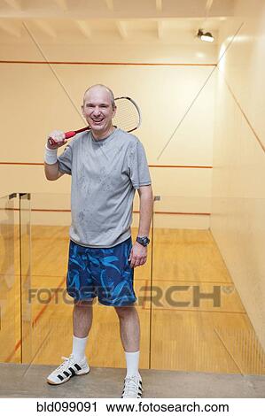 Hispanic man relaxing after racquetball View Large Photo Image Stock Image - Hispanic man relaxing after racquetball. Fotosearch