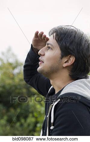 Stock Photo - Hispanic man searching for something. Fotosearch