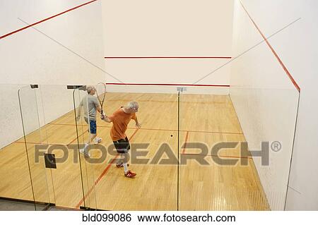 Stock Photograph - Hispanic men playing racquetball. Fotosearch