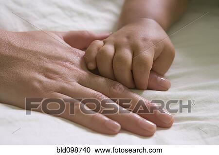 Hispanic mother and baby boy holding hands View Large Photo Image Stock Image - Hispanic mother and baby boy holding hands. Fotosearch