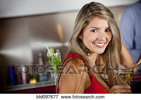 Stock Photo - Hispanic woman drinking martini. Fotosearch